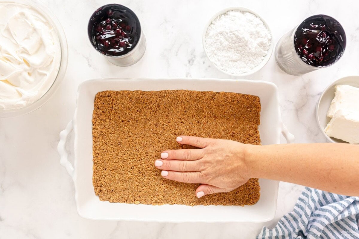 pressing graham cracker crust into pan