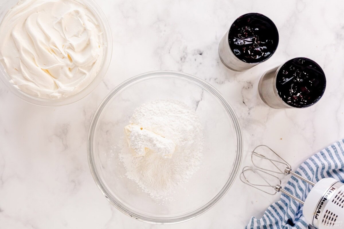 cream cheese and powdered sugar in a bowl