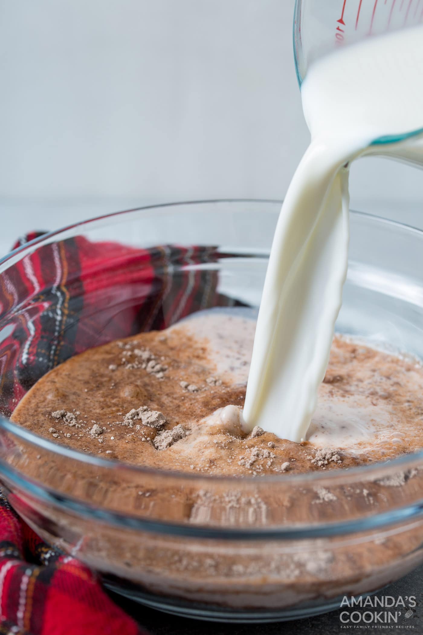 pouring milk into chocolate pudding mix