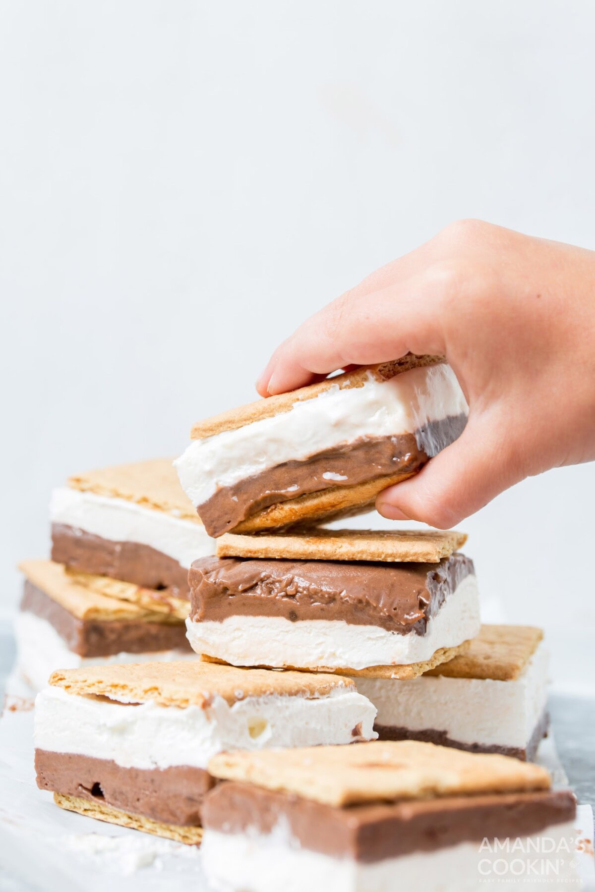 child taking a frozen smore sandwich