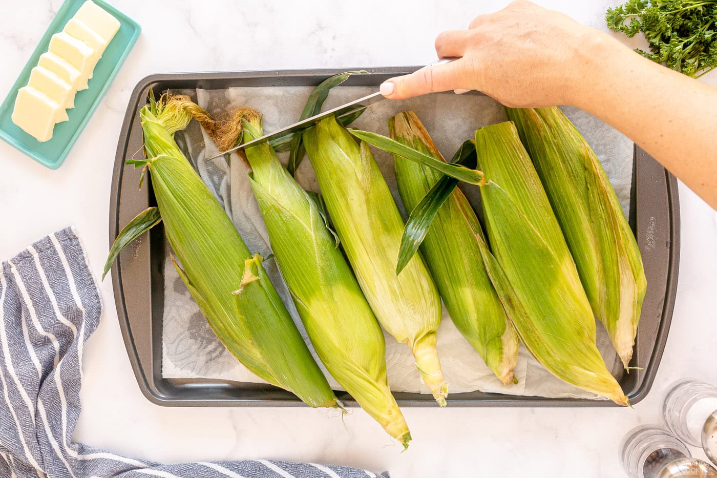 corn drying on a baking sheet with paper towels