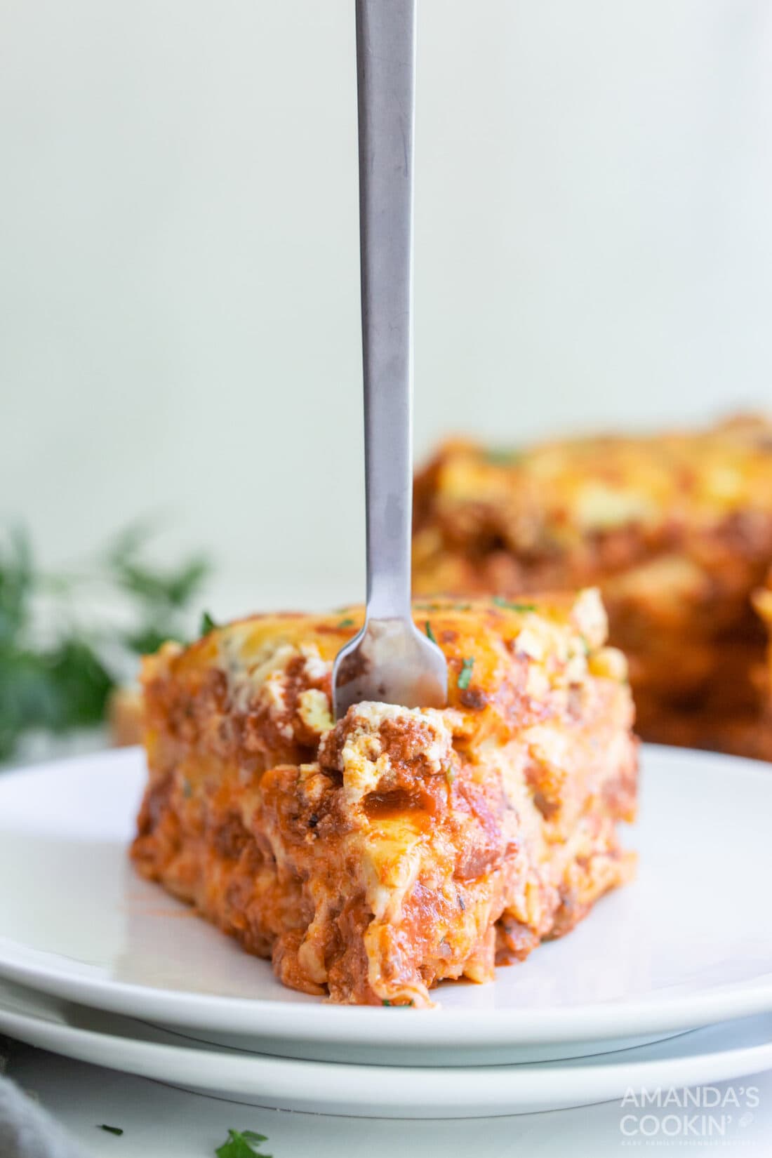 fork in a slice of Instant Pot Lasagna