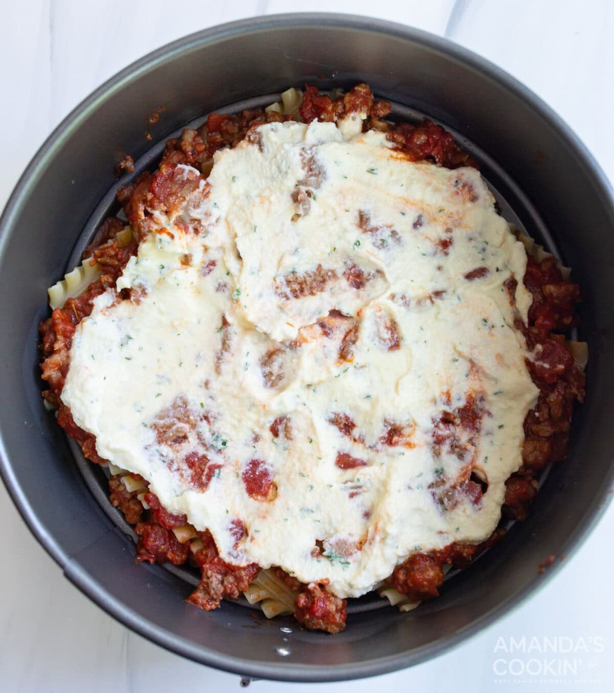 ricotta mixture on top of lasagna noodles in a pan