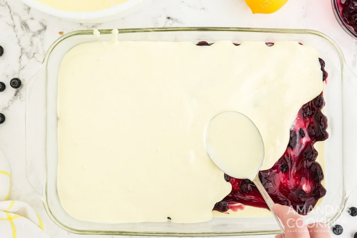 layering pudding on top of blueberry pie filling