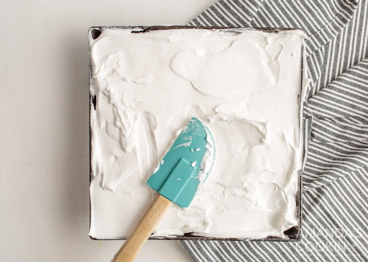 flatting meringue topping on top of lemon curd