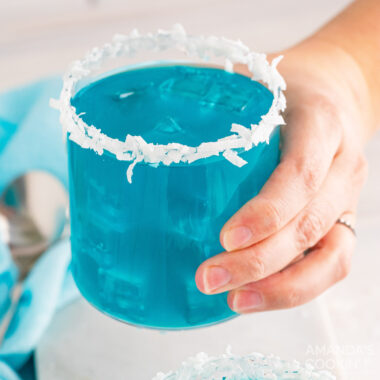 holding a glass of Ocean Water Cocktail