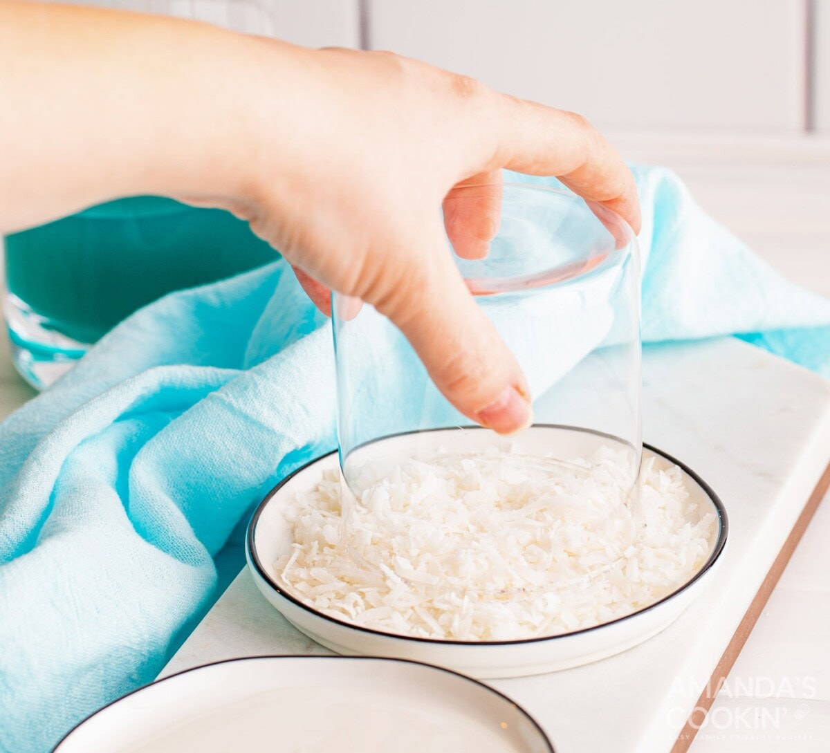 dipping glass in coconut shavings