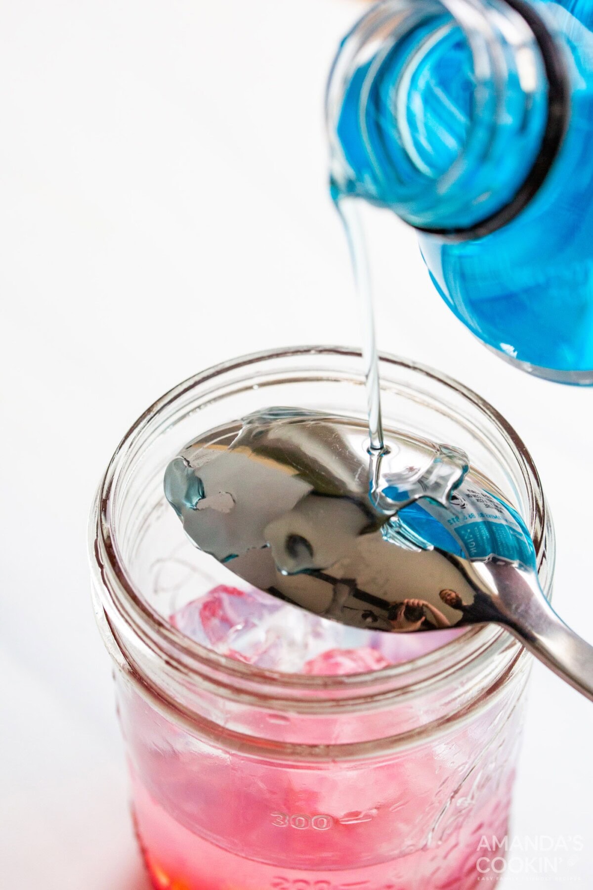 pouring blue powerade over spoon