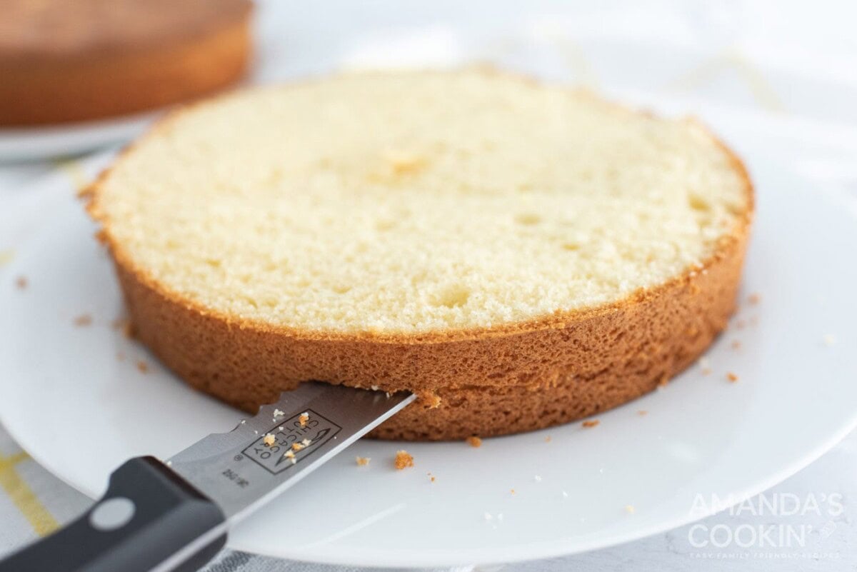 knife cutting cake in half
