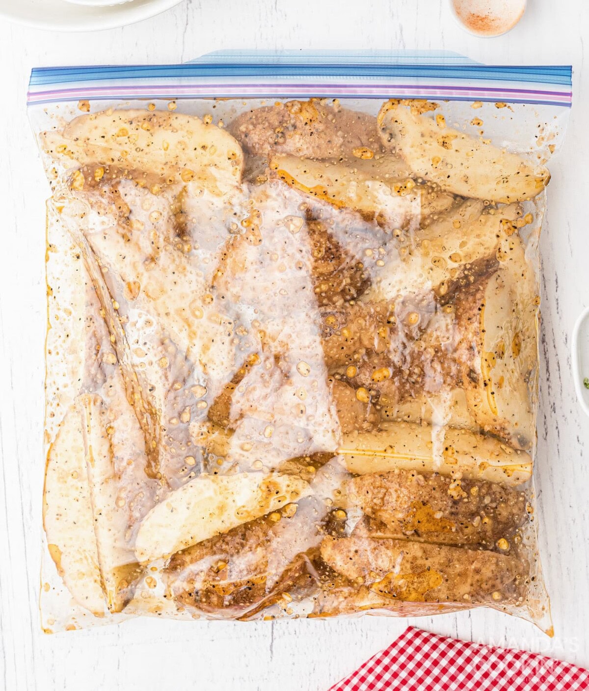 potato wedges with seasoning in a Ziploc bag