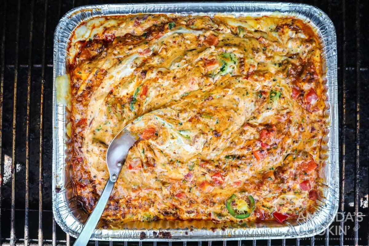 finished smoked queso dip in a pan inspired by tik tok
