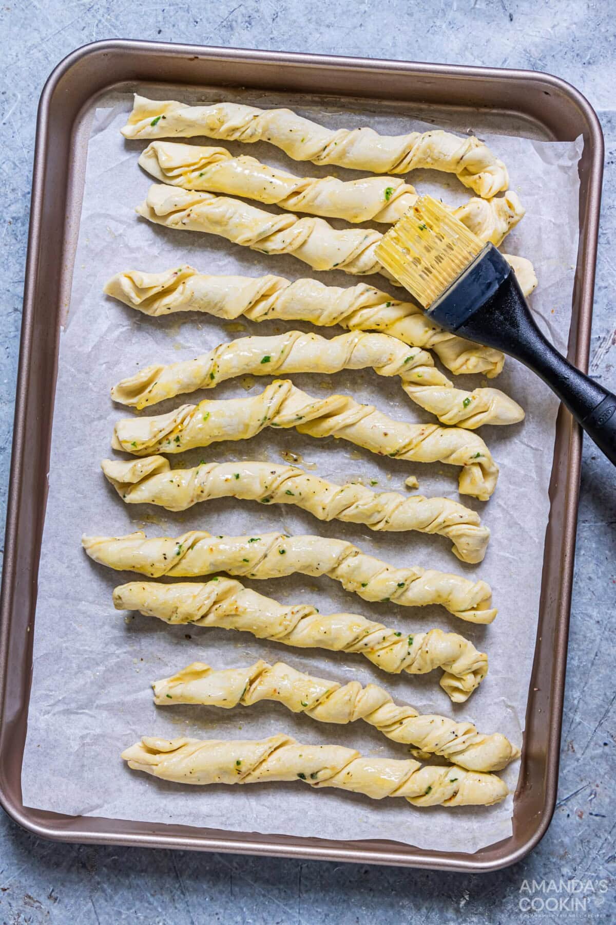brushing parmesan twists with butter