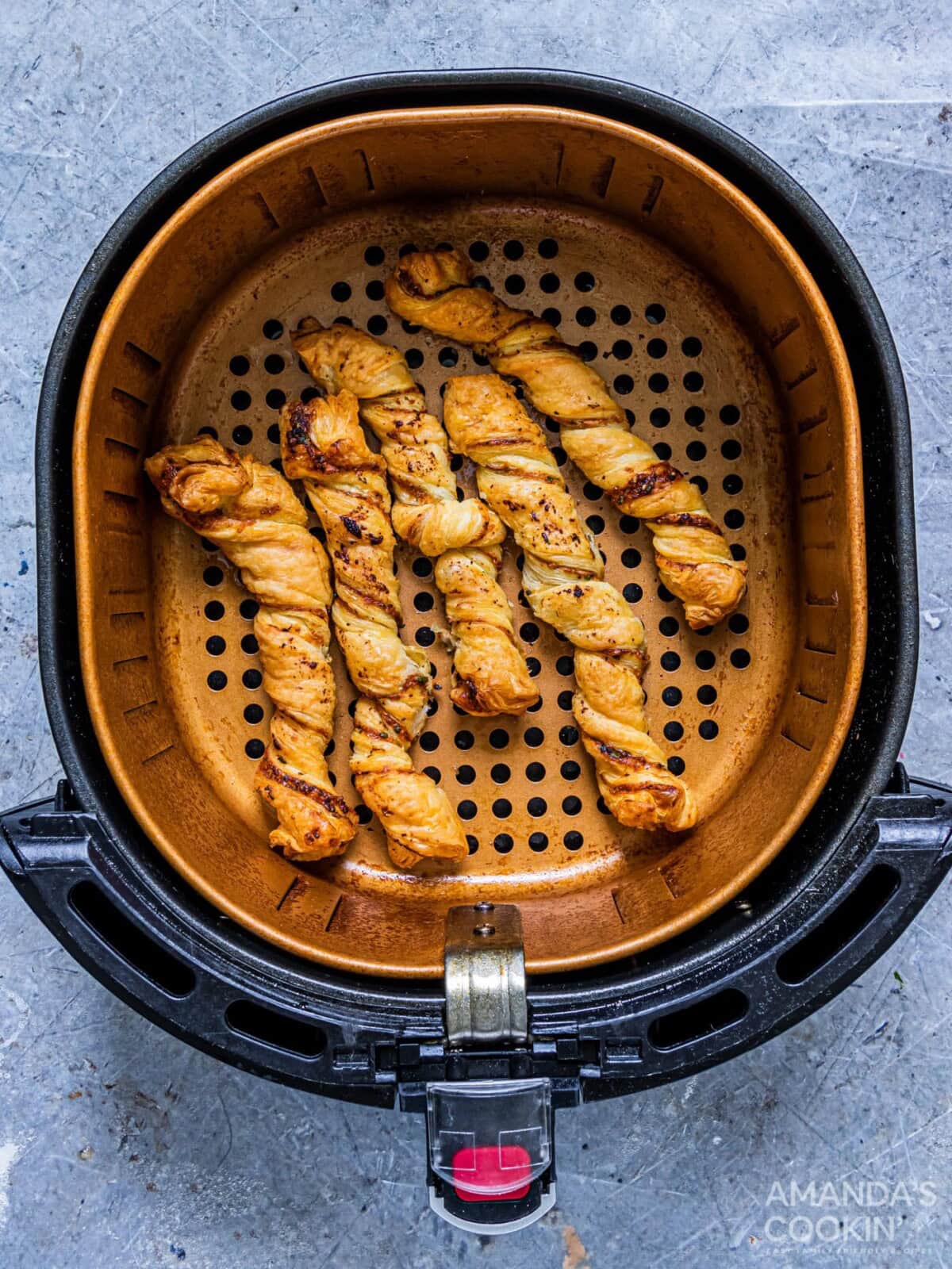 golden brown garlic parmesan twists in an air fryer