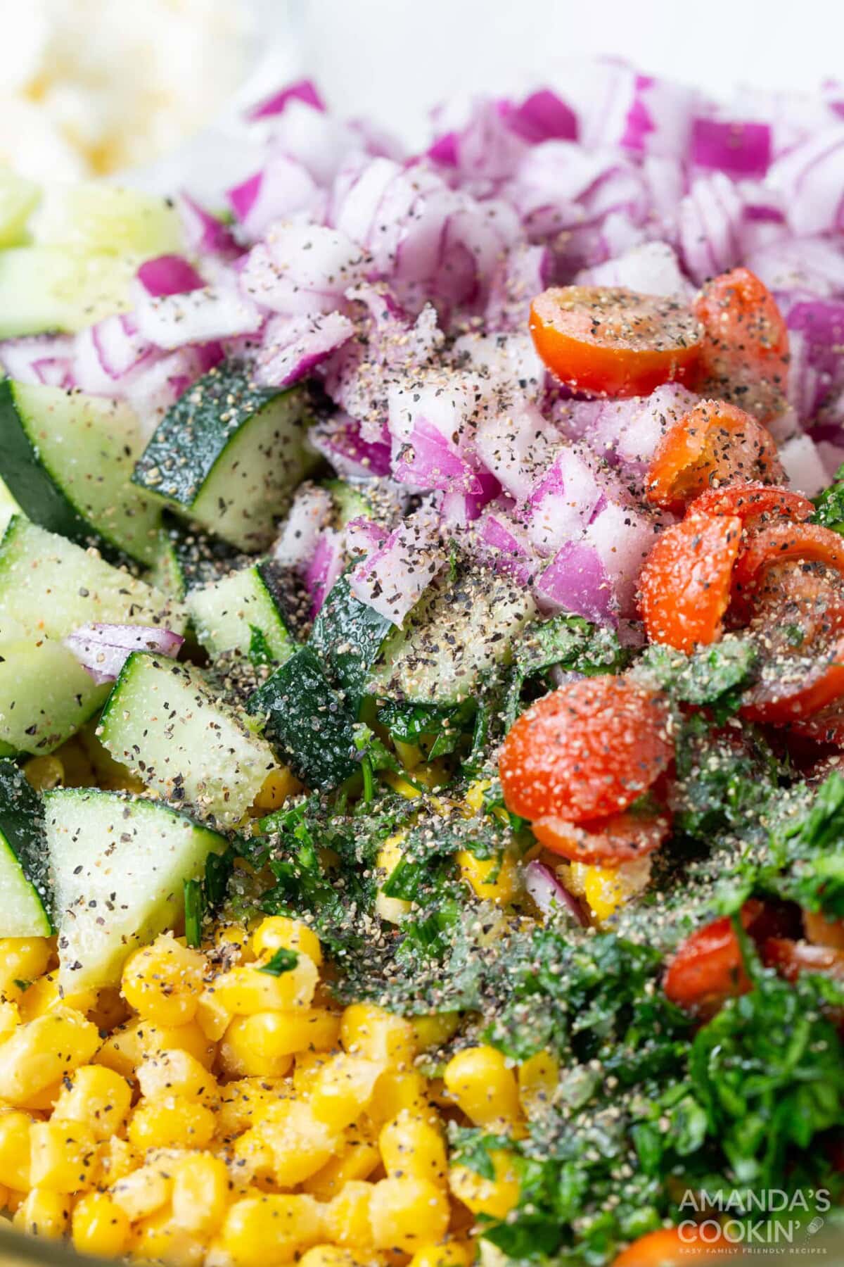 pepper and salt on veggies in a bowl