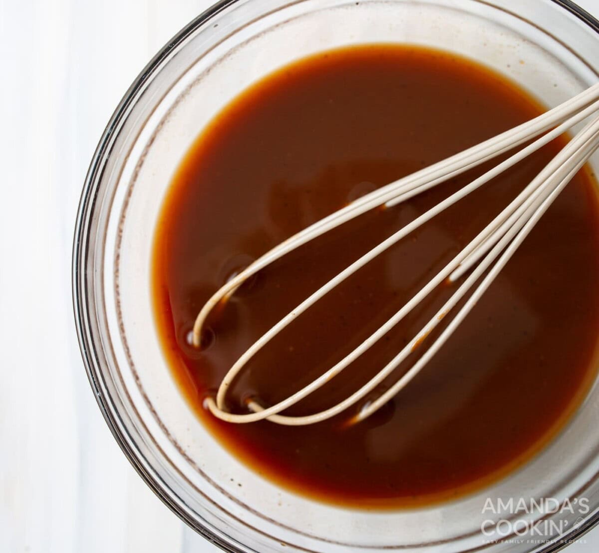 pulled pork sauce in a bowl with whisk