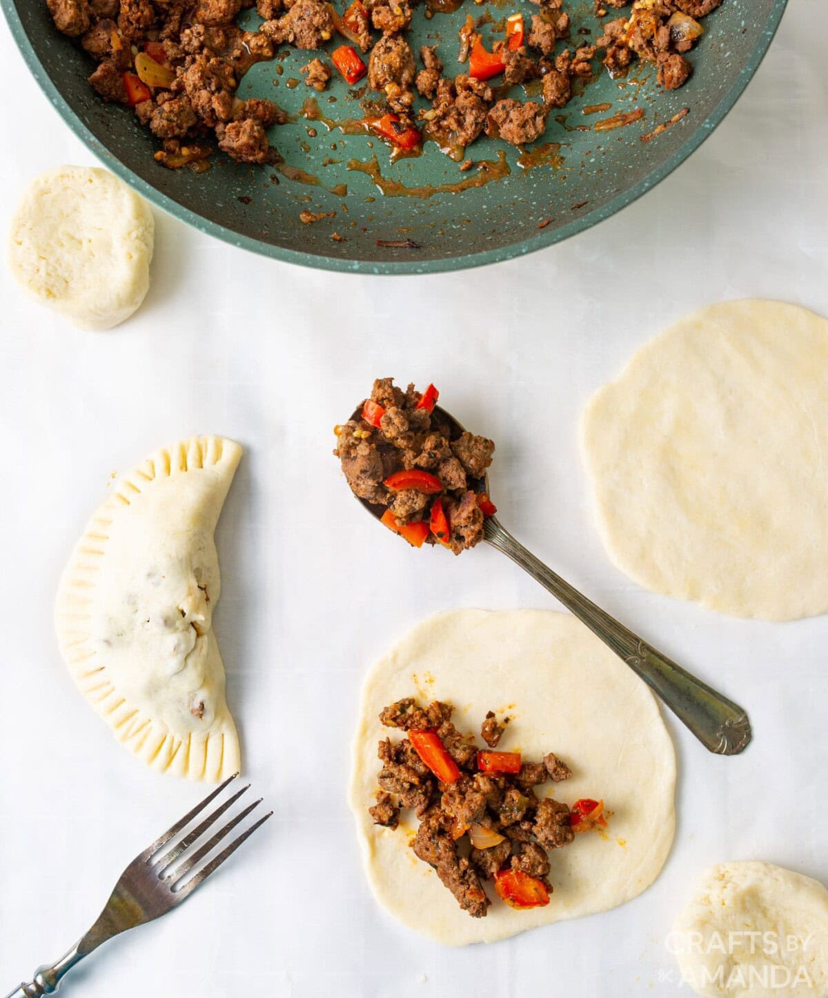 filling pie dough discs with ground beef mixture
