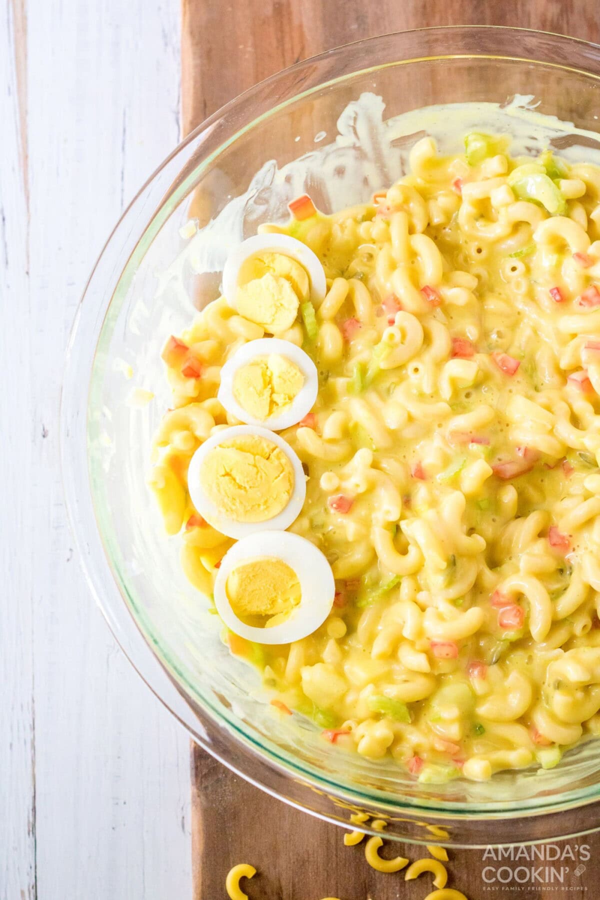 bowl of Amish Macaroni Salad garnished with boiled egg slices