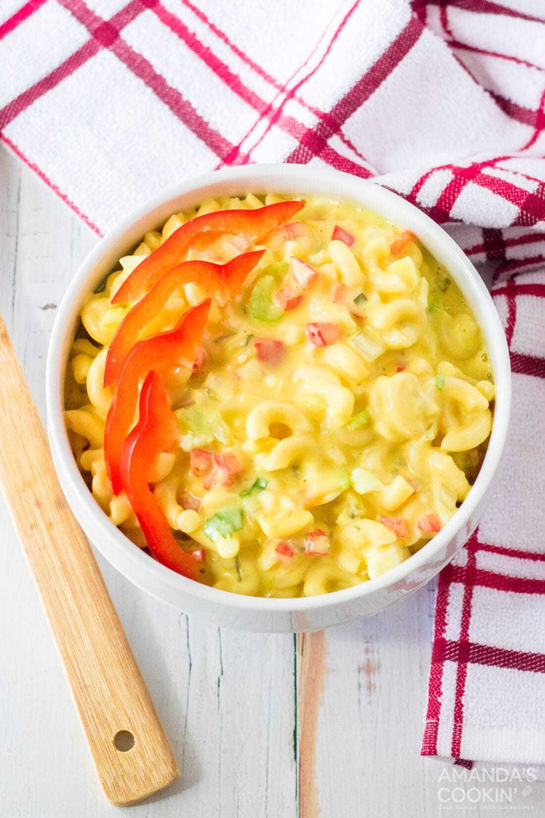 small bowl of Amish Macaroni Salad garnished with red bell pepper