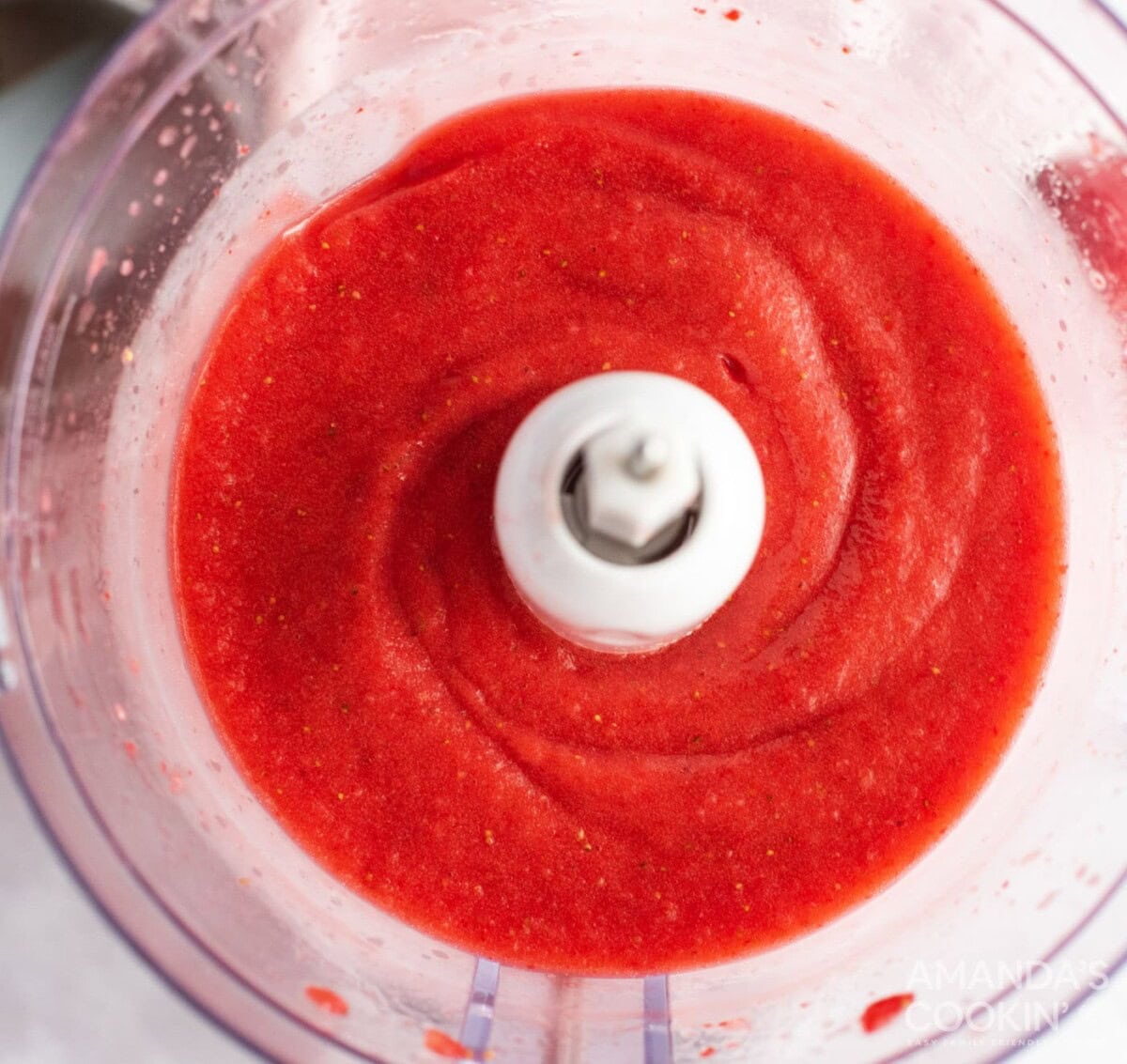 strawberries being pureed in food processor