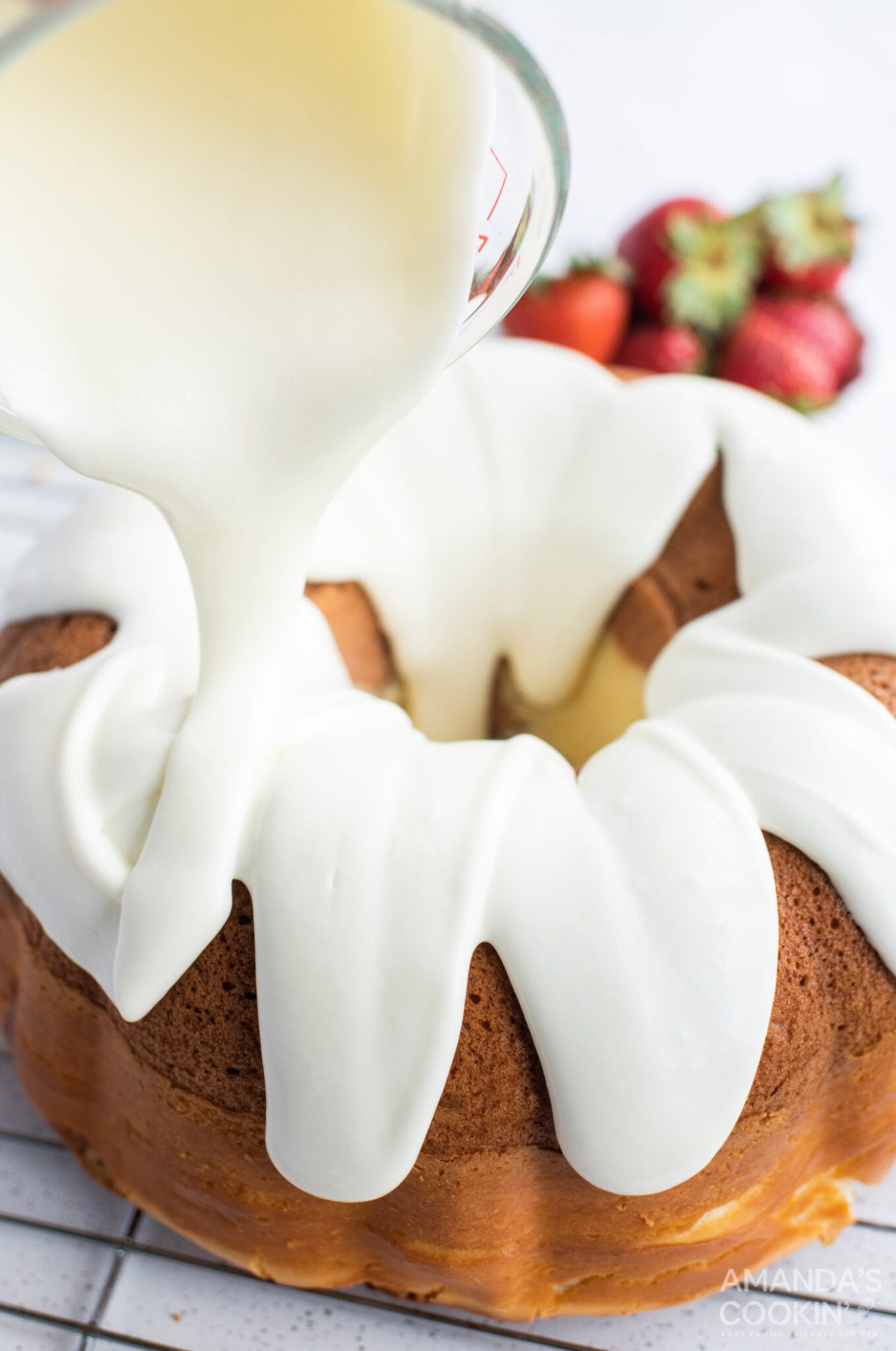 pouring icing on cake
