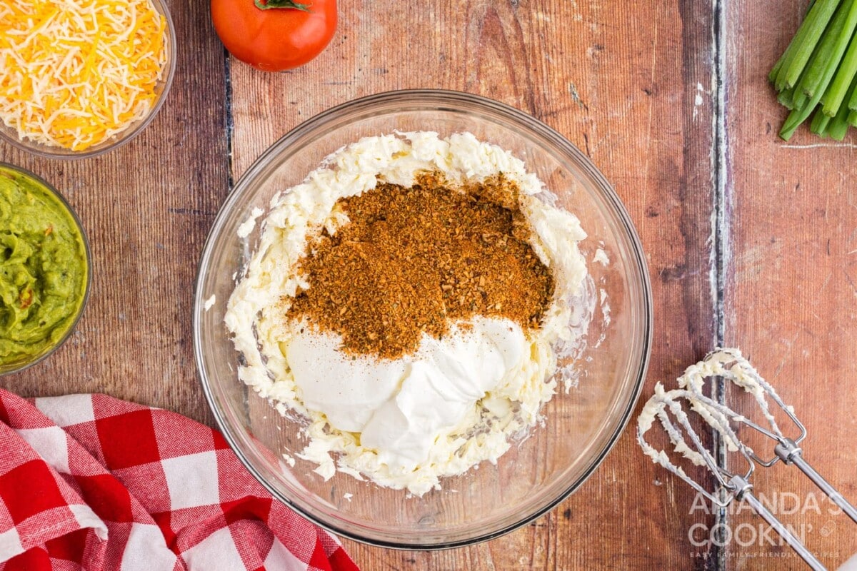 cream cheese, sour cream, and taco seasoning in a bowl