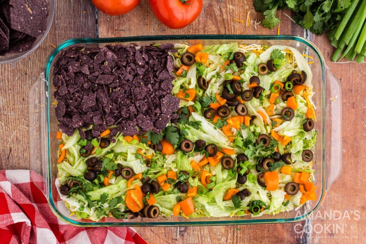 crushed blue tortilla chips on left side of taco dip