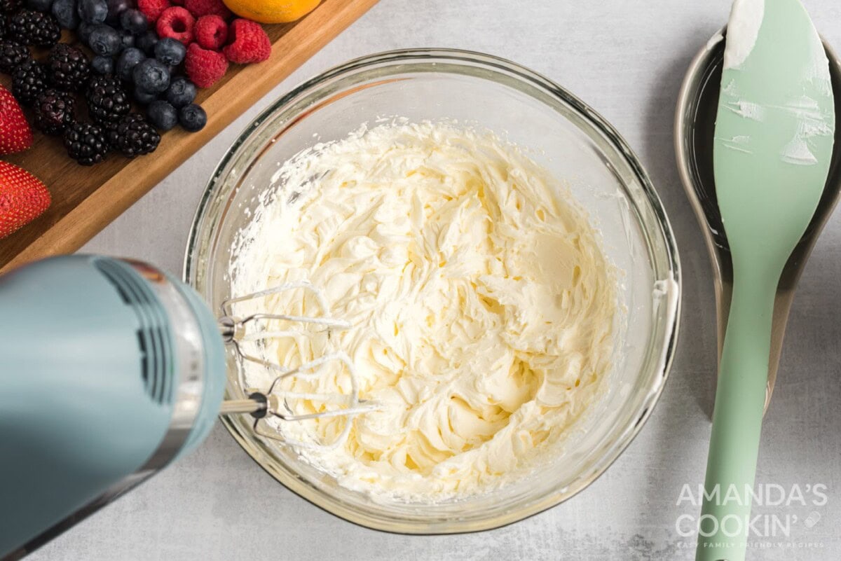 hand mixer beating cream cheese mixture