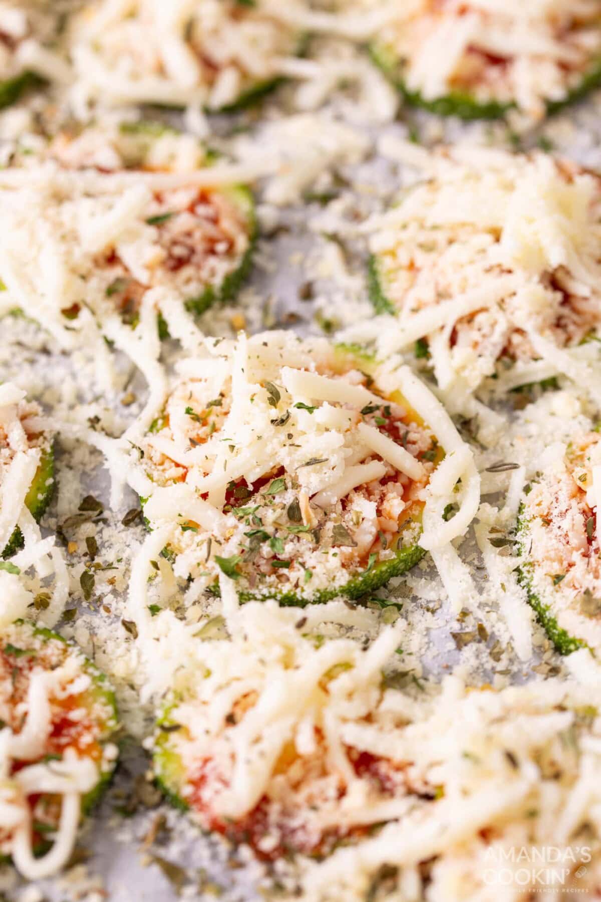 cheese and seasonings on zucchini slices