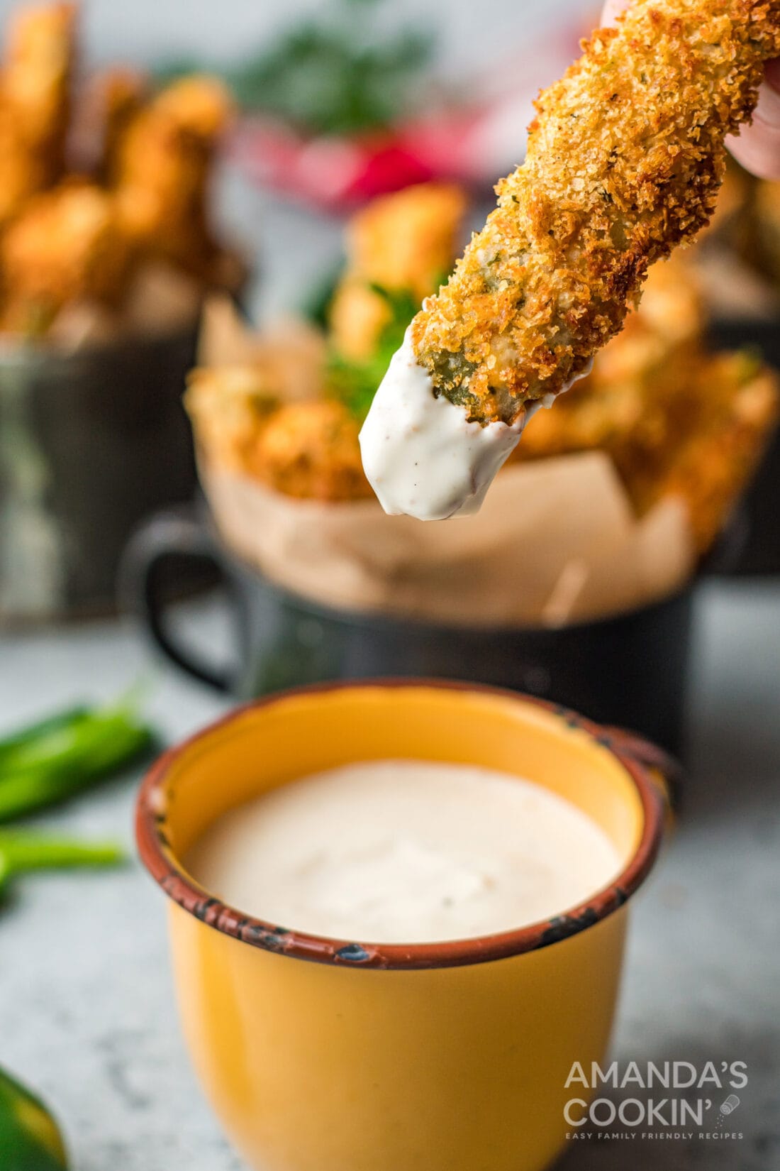 dipping an Air Fryer Jalapeno Fry in sauce