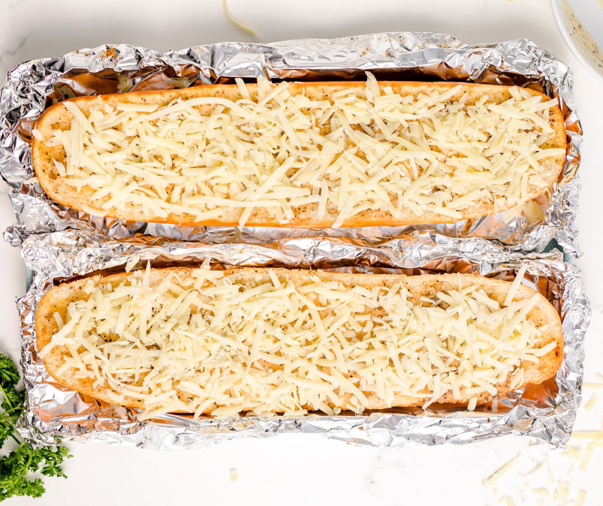 cheesy garlic bread on a pan with aluminum foil