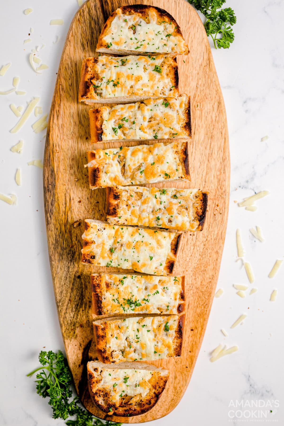 sliced Cheesy Garlic Bread on a cutting board