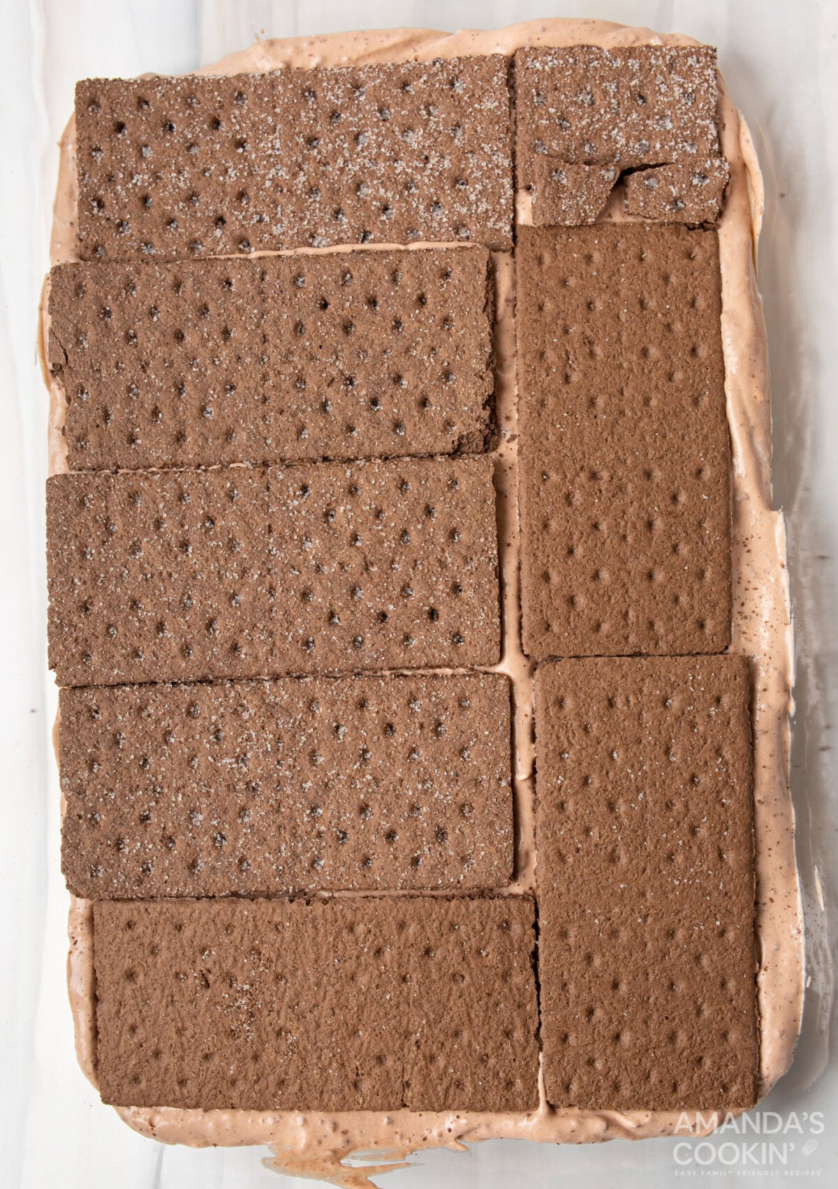 graham crackers on top of chocolate pudding mix in baking dish