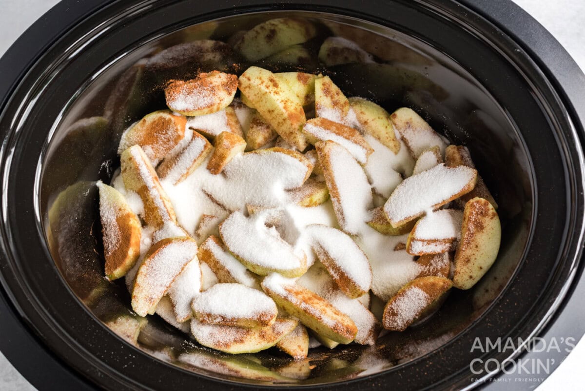 sugar and cinnamon on apple slices in crockpot