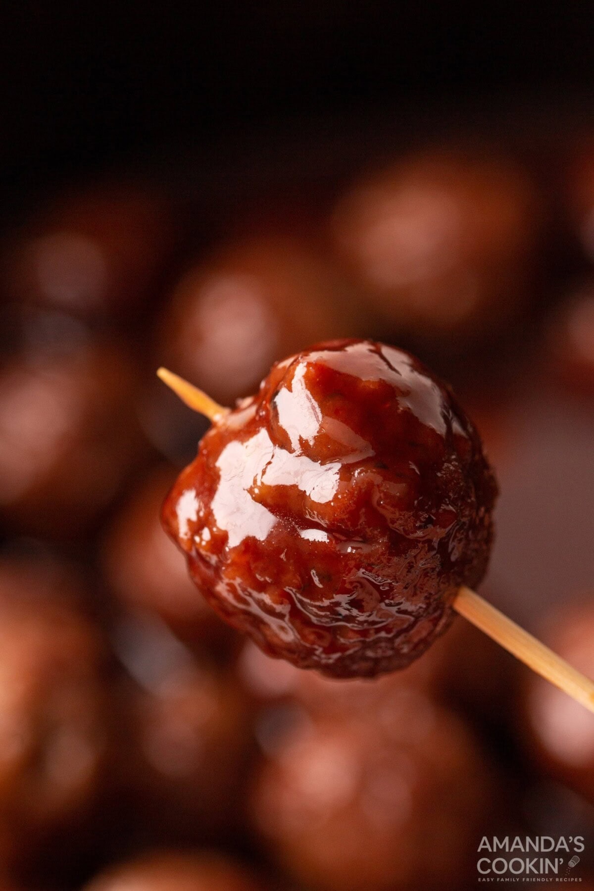 holding grape jelly meatball with a toothpick