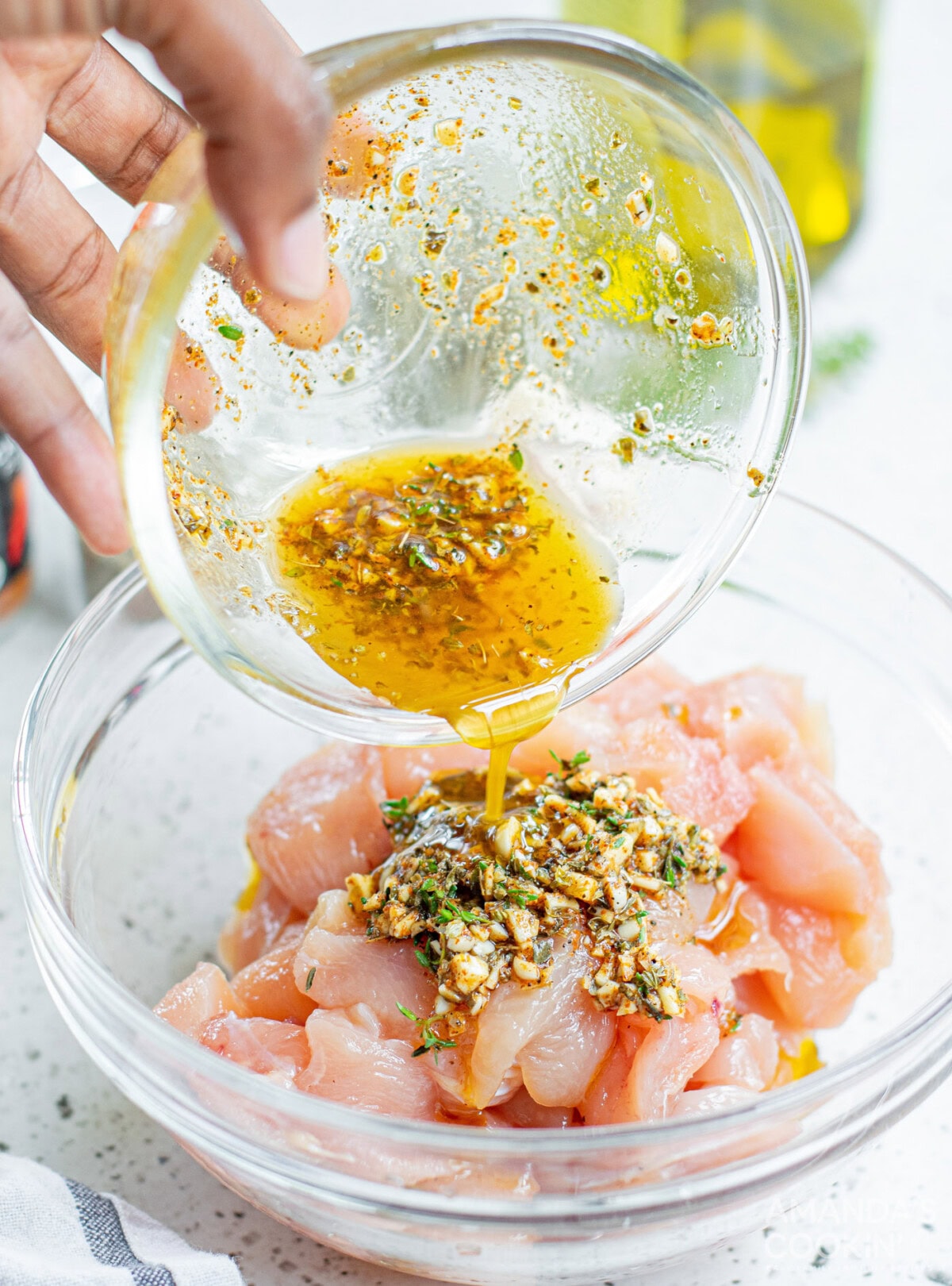 pouring marinade on chicken