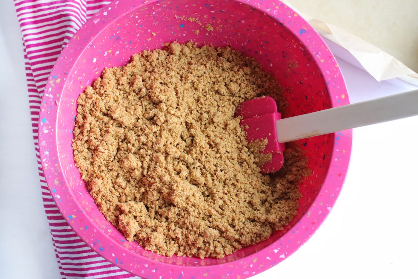 graham cracker crumbs in a bowl with rubber spatula