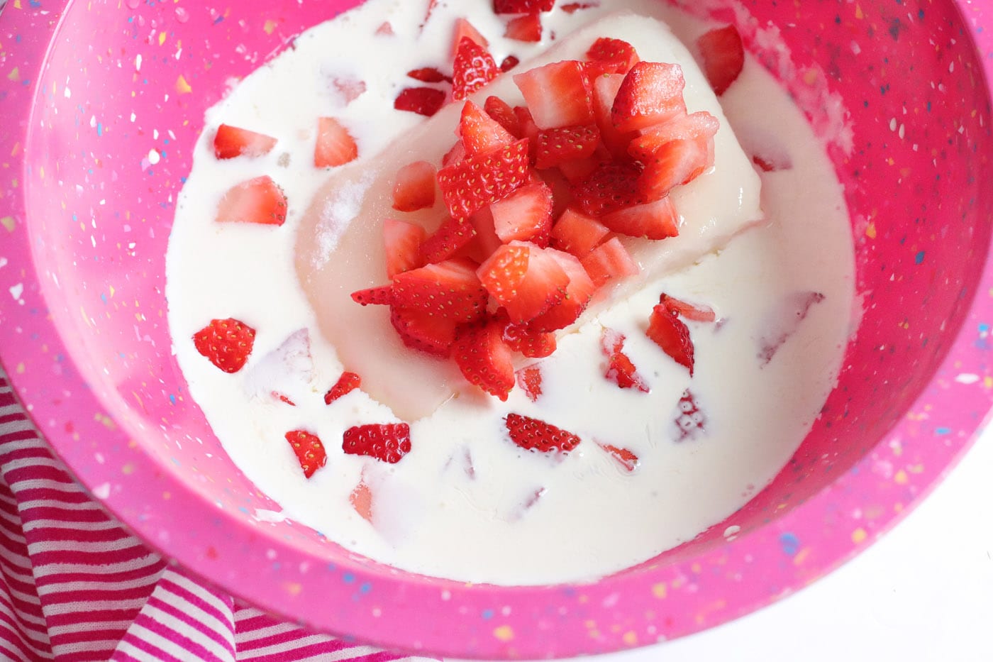 cream cheese mixture with fresh chopped strawberries in a bowl