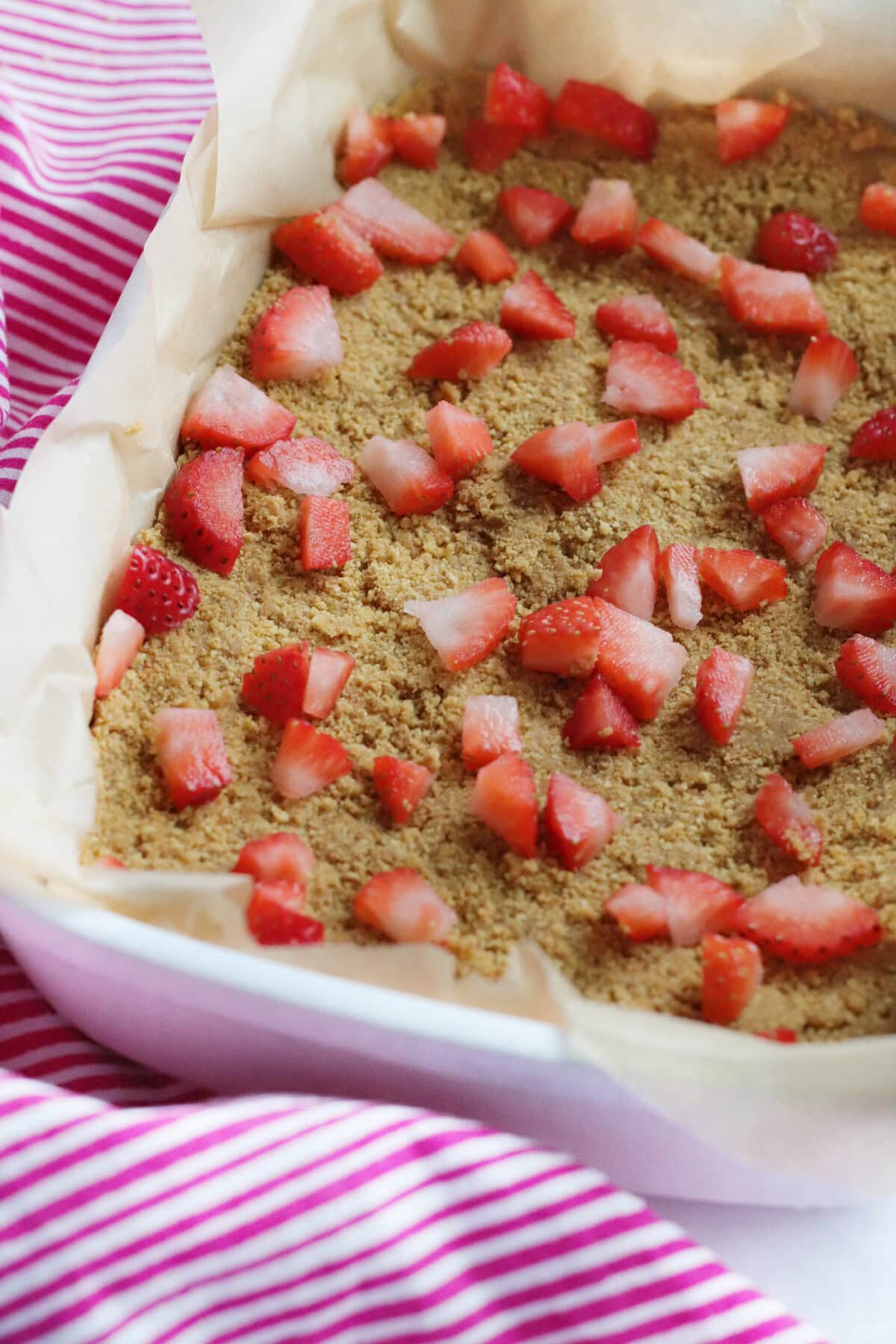 chopped strawberries on graham cracker crust