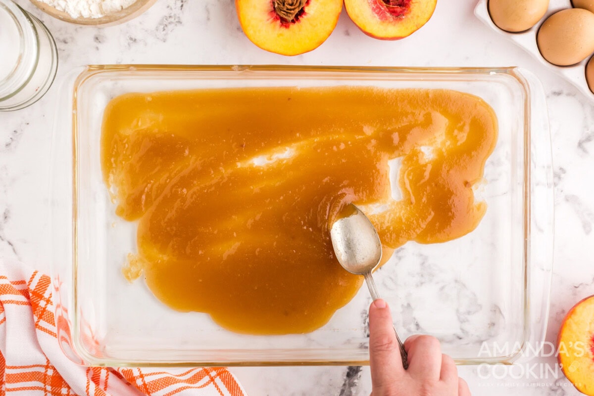 melted butter and brown sugar spread onto glass baking dish