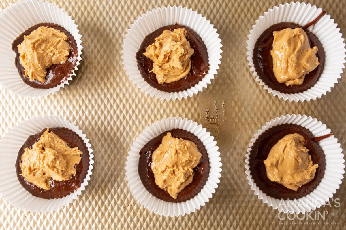 peanut butter on top of chocolate in a cupcake liner