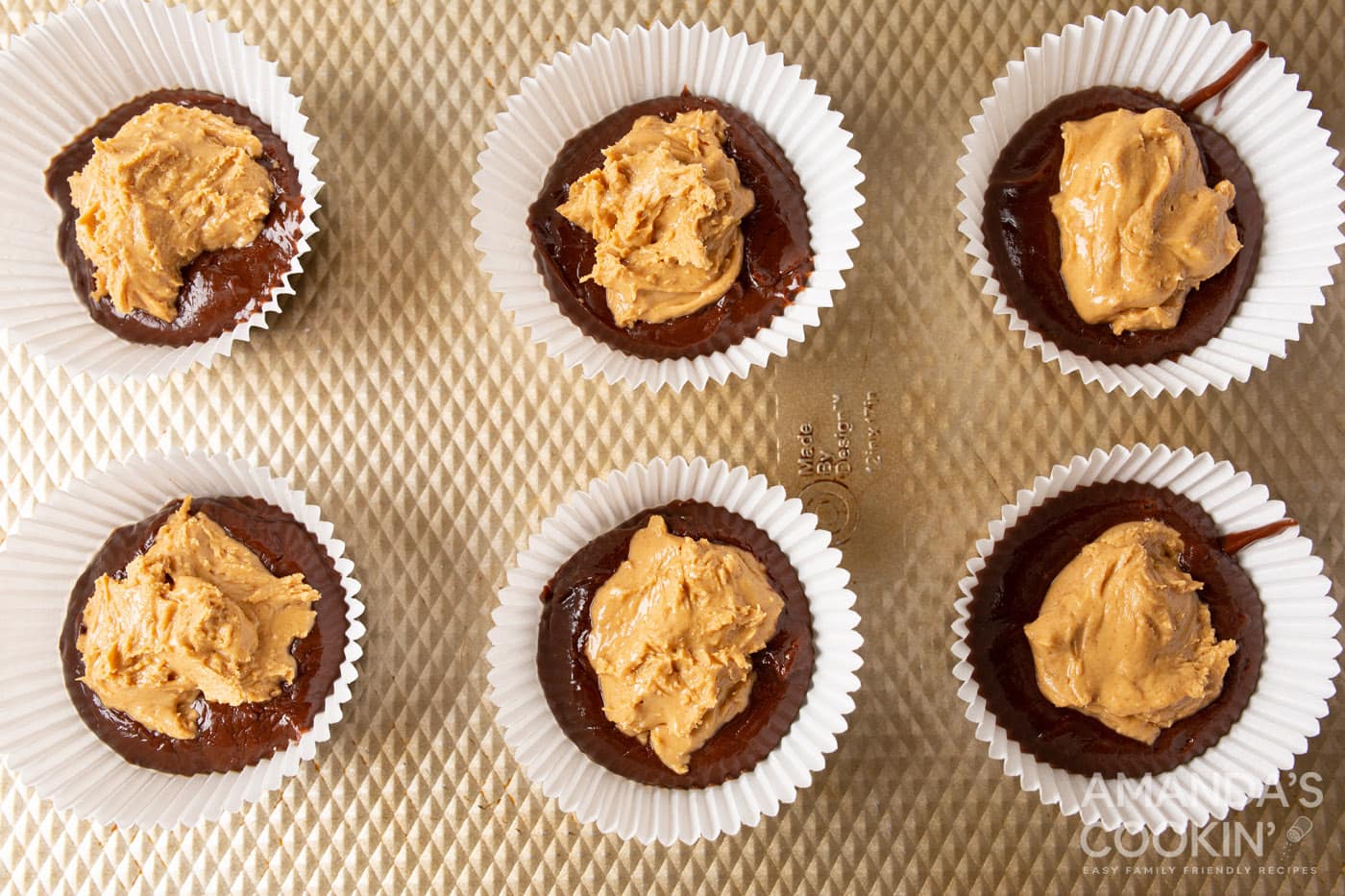 peanut butter on top of chocolate in a cupcake liner