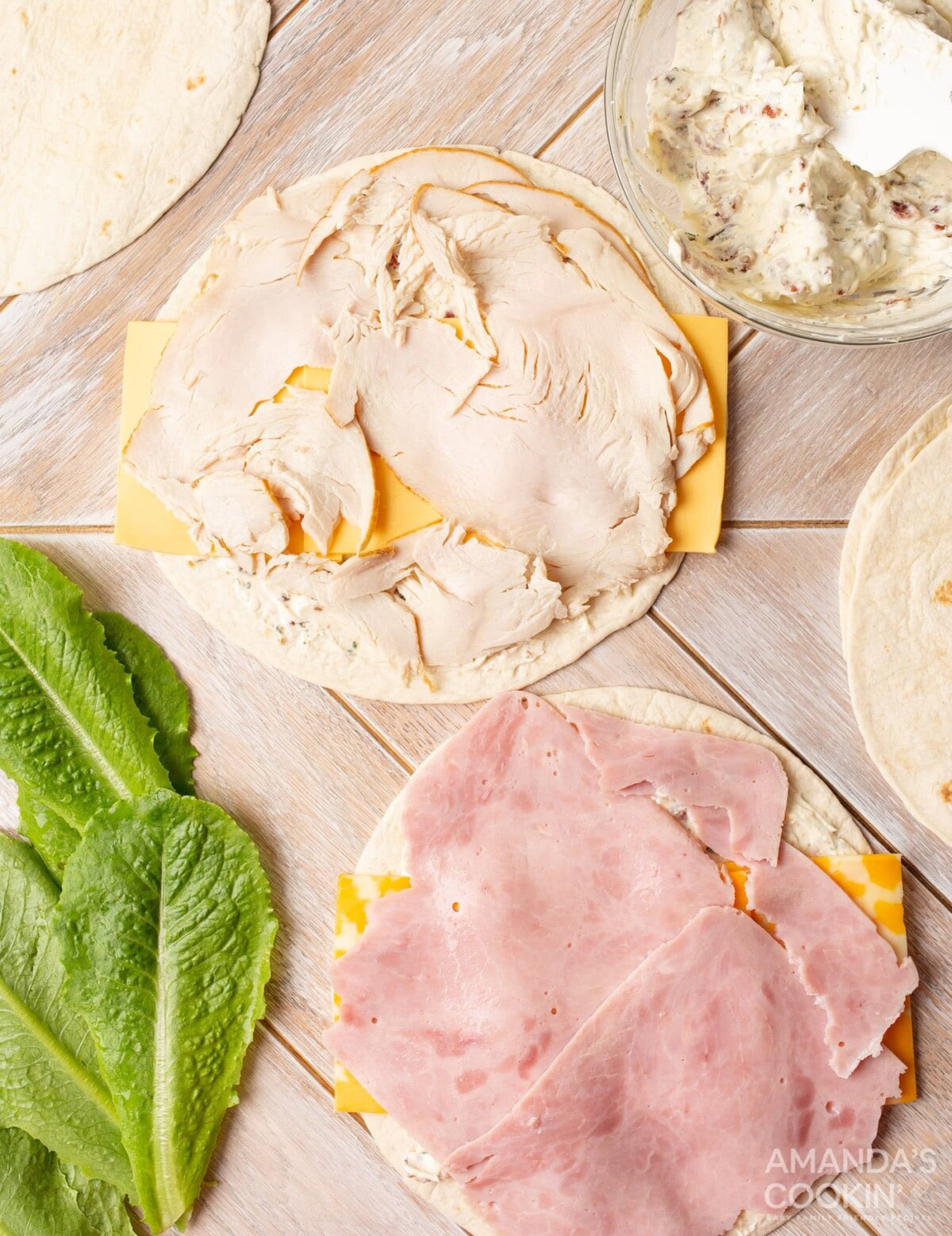 deli meat on top of tortilla with cream cheese and cheese slices