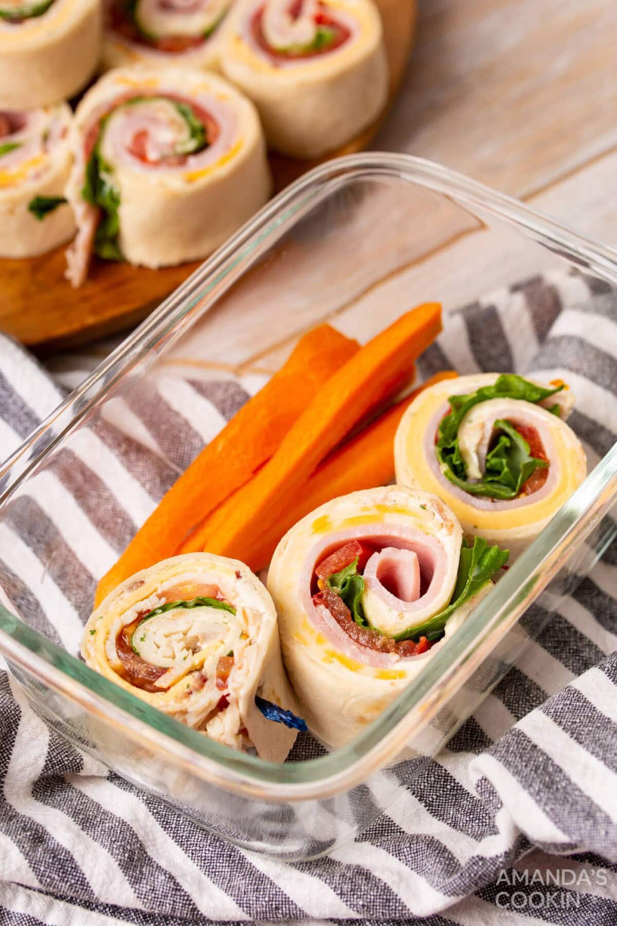 Pinwheel Sandwiches in a lunch container with carrots