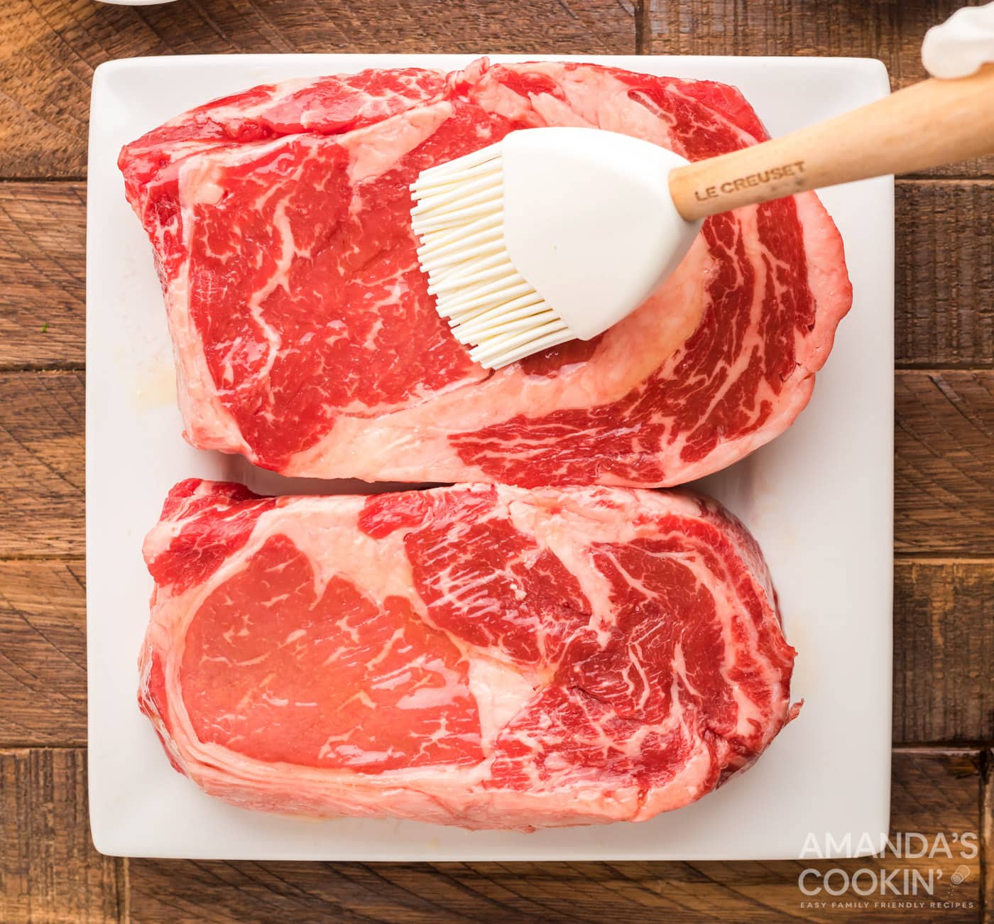 brushing ribeye meat with olive oil