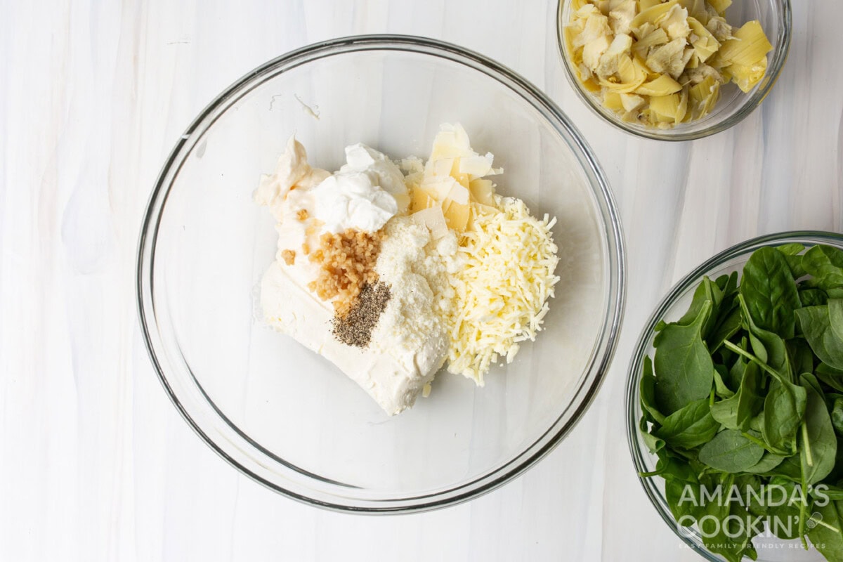spinach artichoke dip ingredients in a mixing bowl