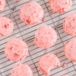 wire rack of frosted pink cookies