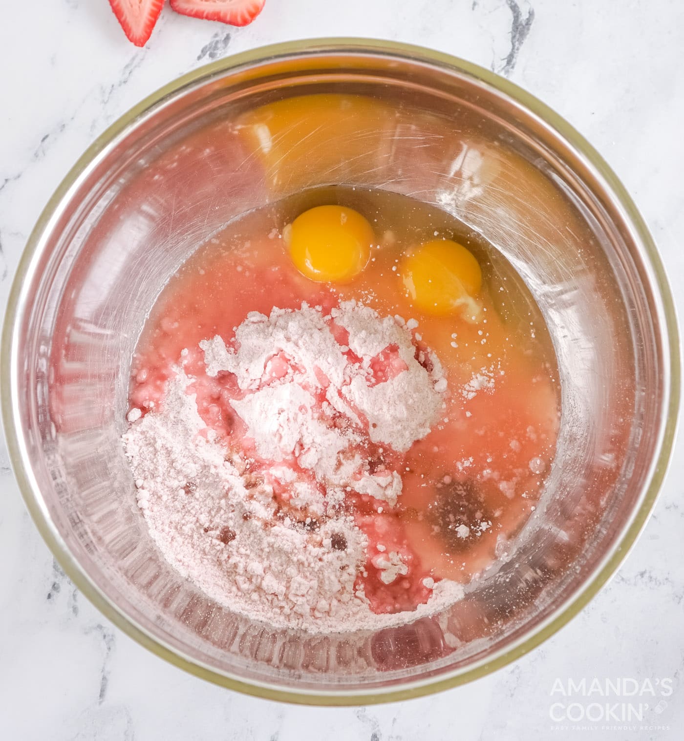 eggs, oil, and strawberry cake mix in a bowl