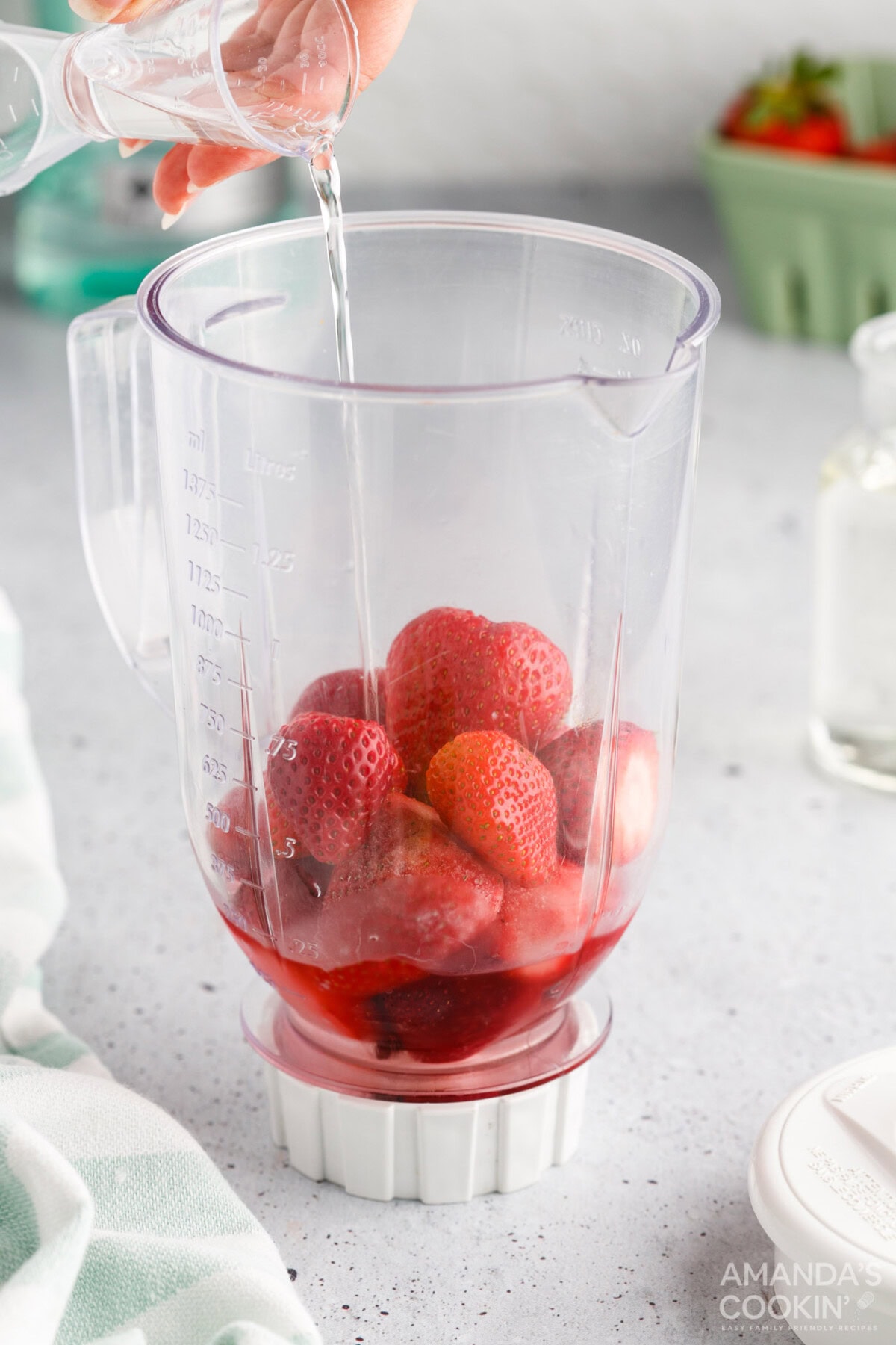pouring simple syrup into strawberry daiquiri blender
