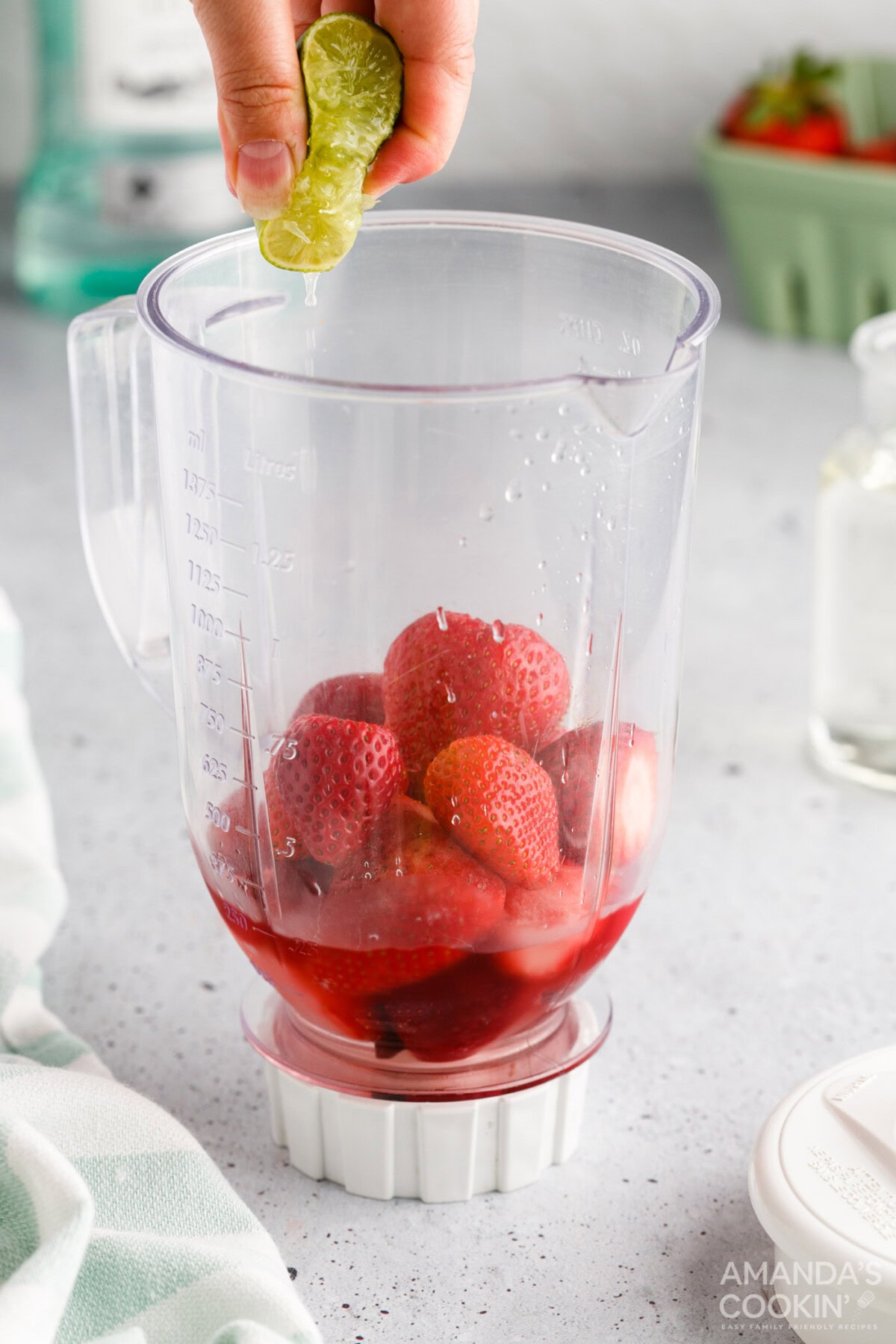 squeezing lime juice into blender