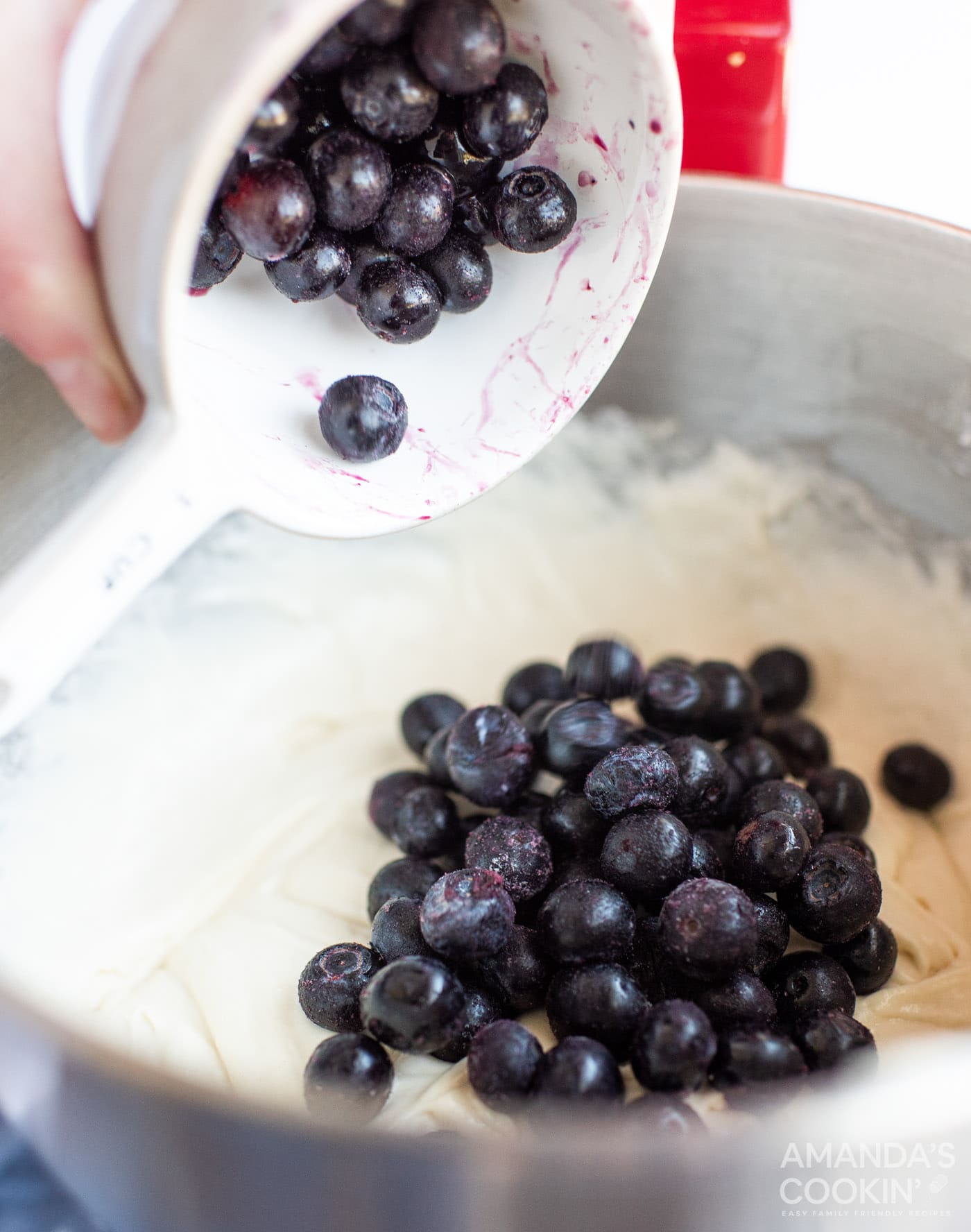 adding blueberries to cake batter